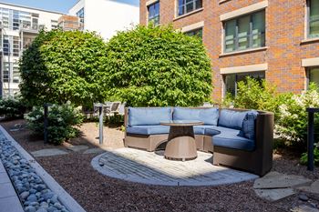 a seating area with a couch and a table in a courtyard